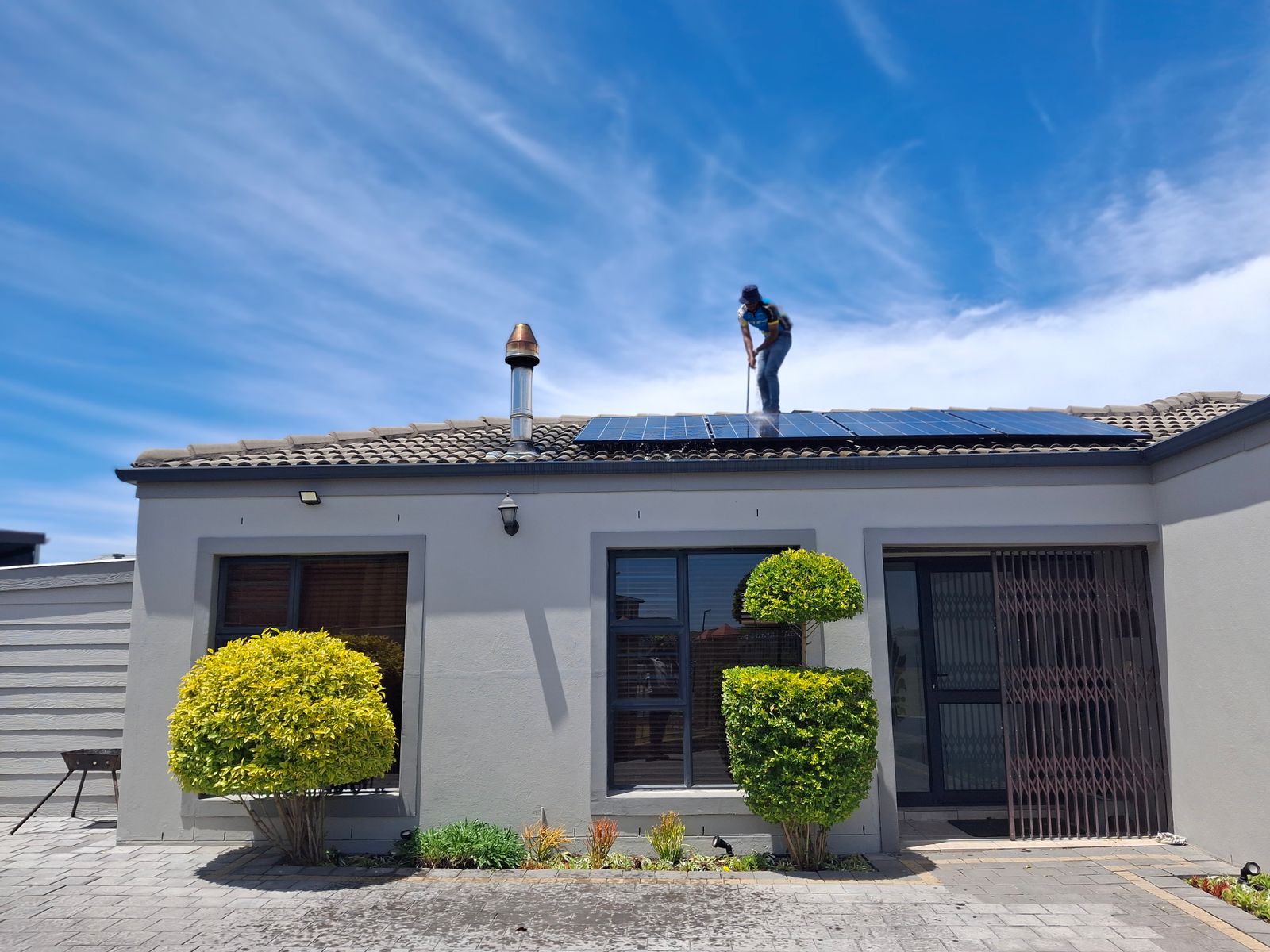 Electrician installing a residential rooftop solar system